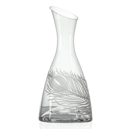 Clear glass carafe with leaf design on a white background