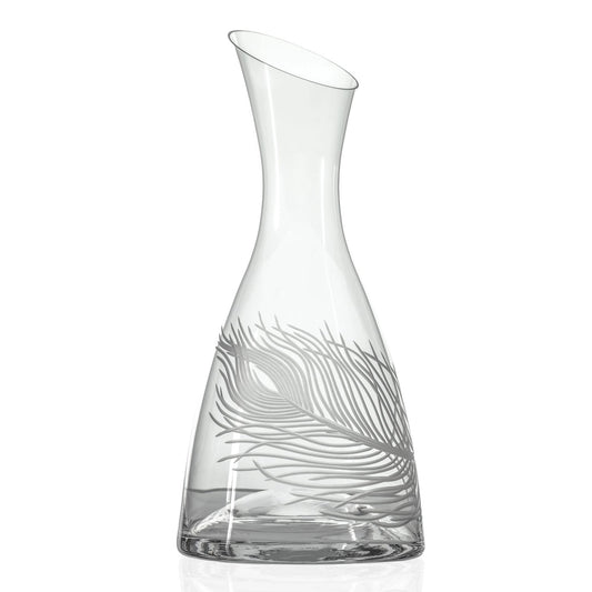 Clear glass carafe with leaf design on a white background