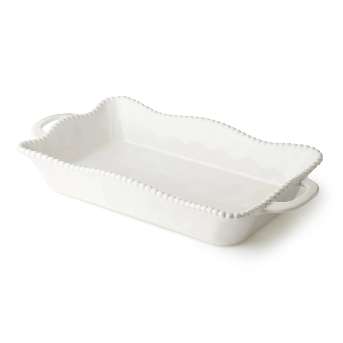 White ceramic serving dish with decorative edge on a white background