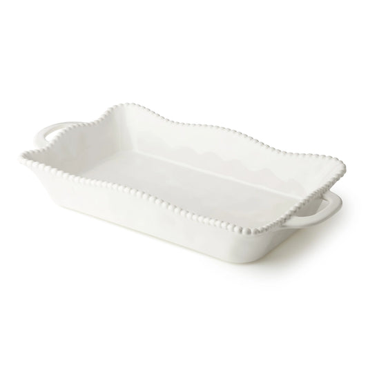 White ceramic serving dish with decorative edge on a white background