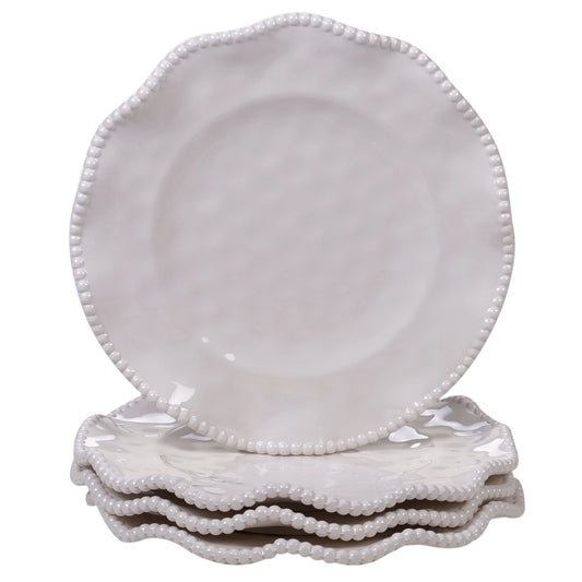 Set of white ceramic plates with decorative rims on a white background