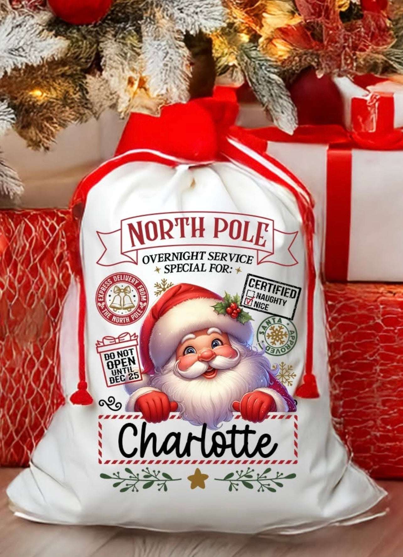 Personalized Santa sack with 'North Pole' and 'Charlotte' text, surrounded by Christmas decorations.