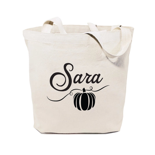 Beige tote bag with 'Sara' and a pumpkin design on a white background