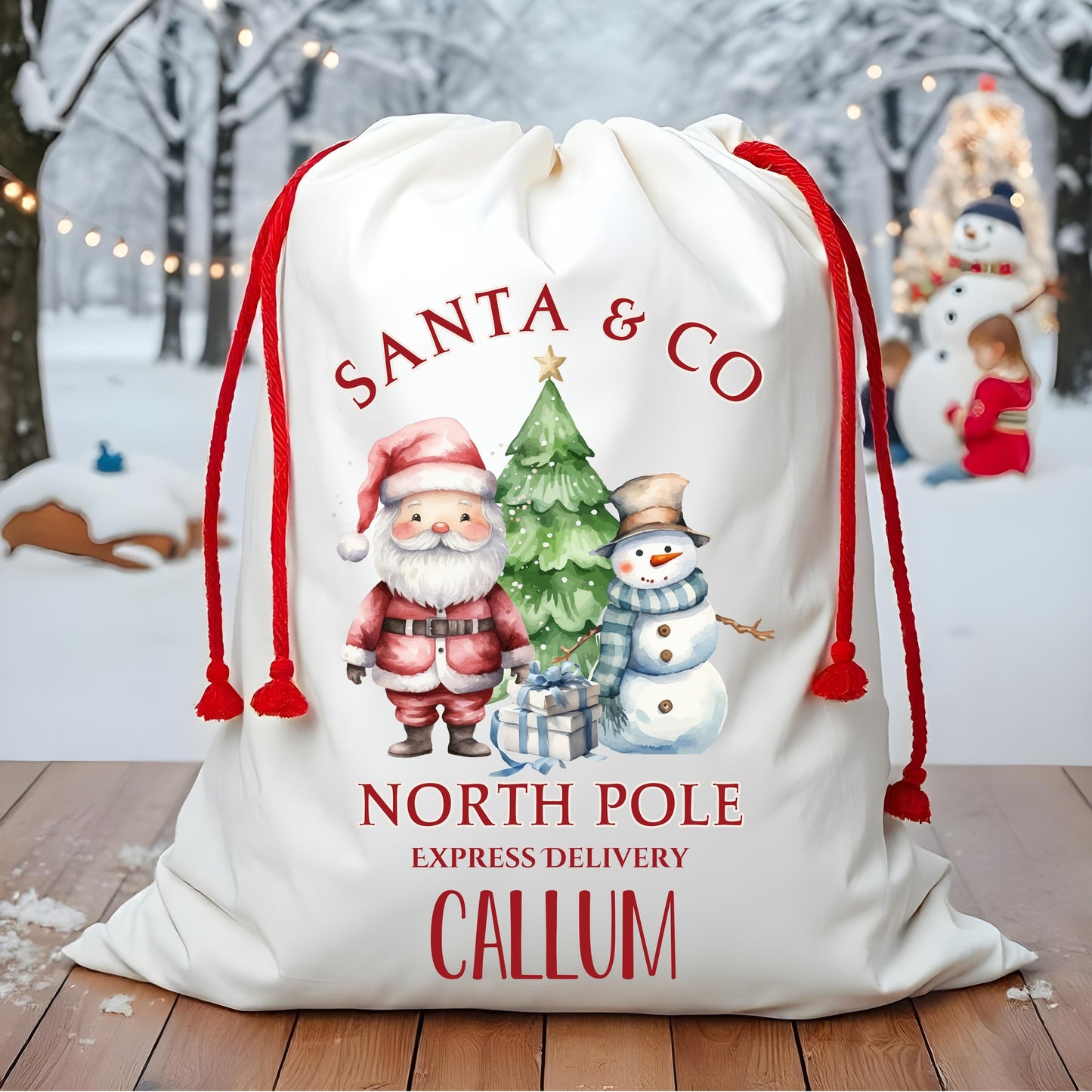 Personalized Santa sack with festive design and text on a wooden floor with a snowy background.