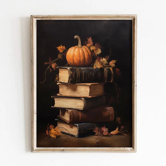 Framed artwork of a pumpkin on books with autumn leaves