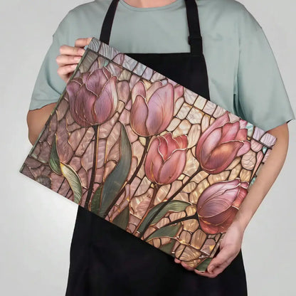 Person holding a decorative tray with pink tulip design against a plain background