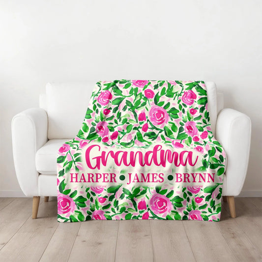 Floral patterned blanket with personalized names on a white armchair.
