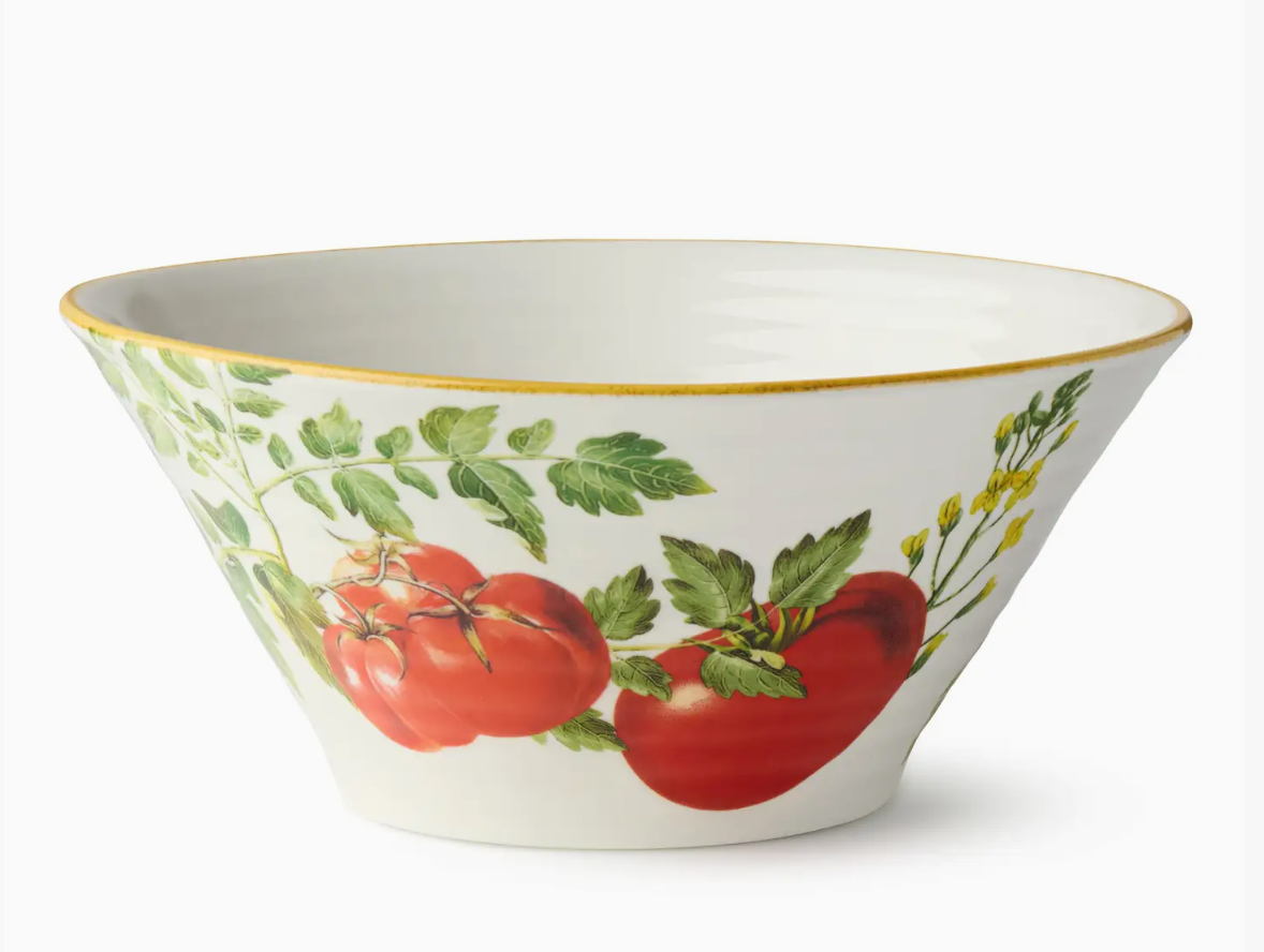 Decorative bowl with tomato and leaf design on a white background
