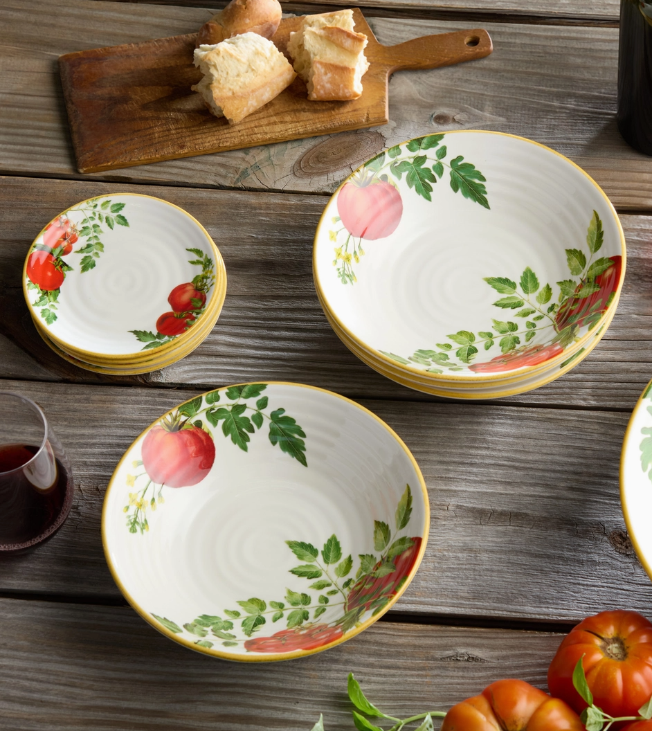 Set of ceramic bowls with fruit design on a wooden table