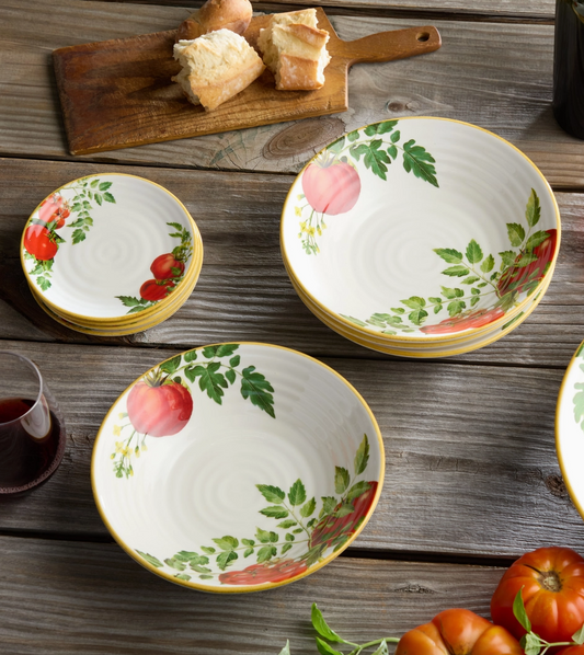 Set of ceramic bowls with fruit design on a wooden table