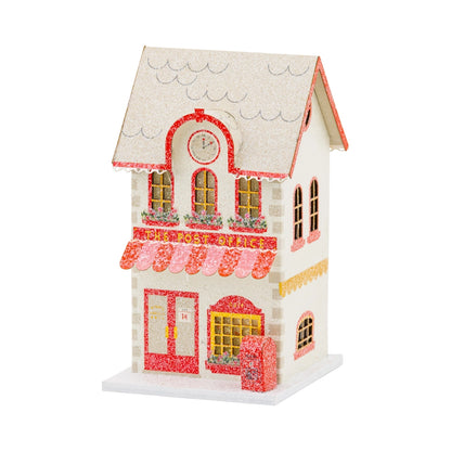 Decorative model of a house with a clock on a white background