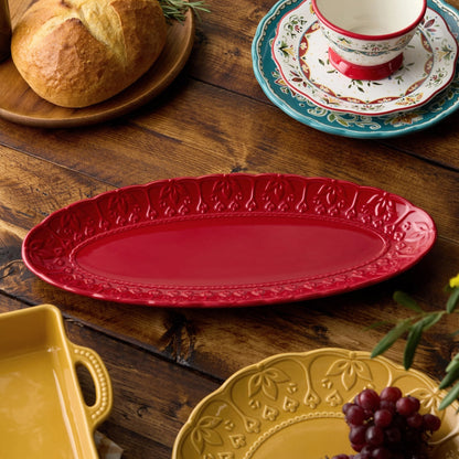 Decorative plates on a wooden table with bread and grapes