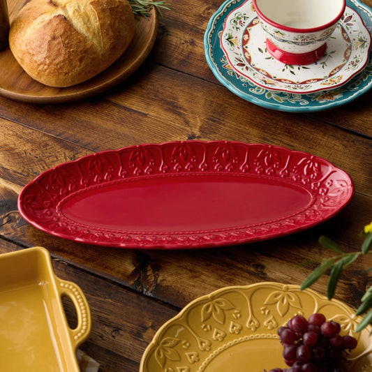 Decorative plates on a wooden table with bread and grapes