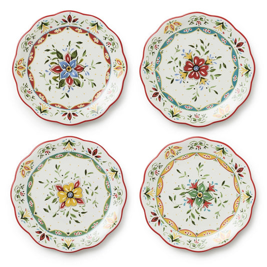 Set of four decorative plates with floral patterns on a white background