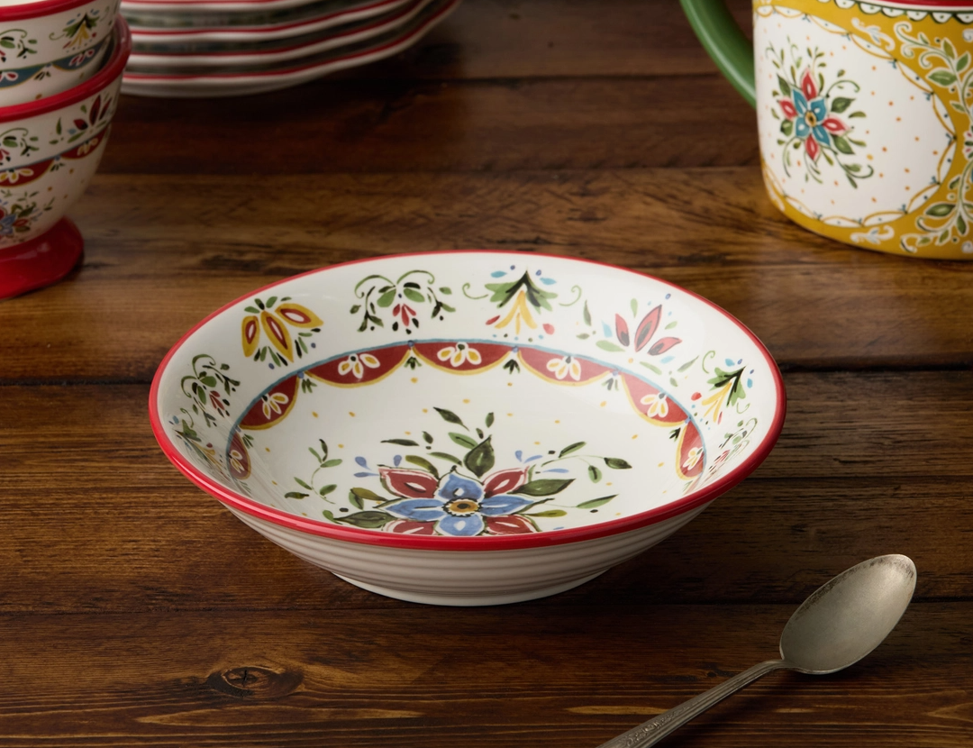 Decorative ceramic bowl with floral patterns on a wooden surface