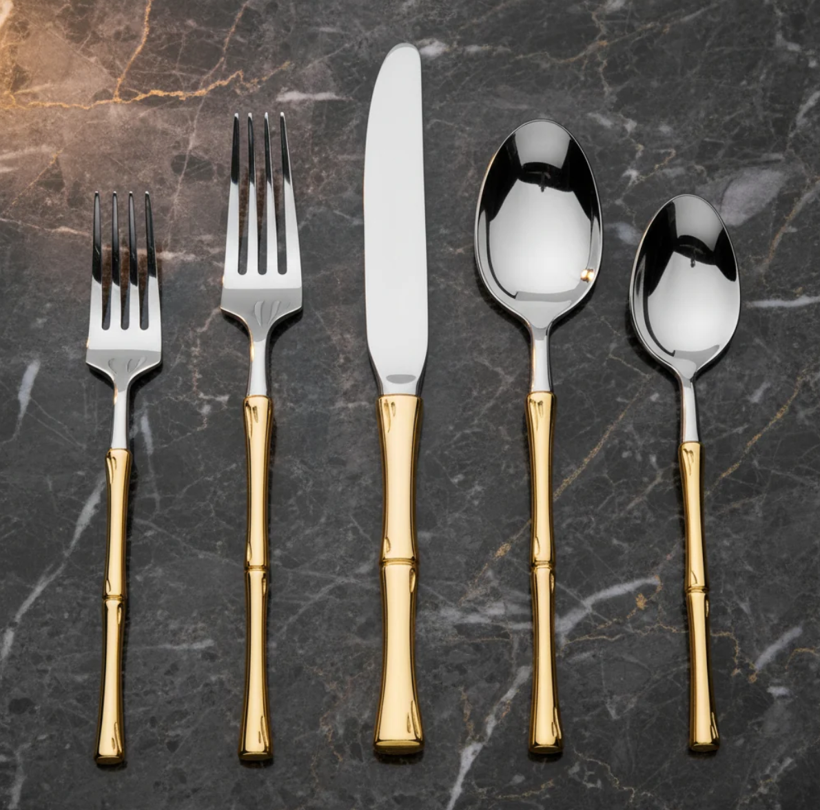 20-piece stainless steel flatware set with elegant gold rattan-inspired handles displayed on dark marble.