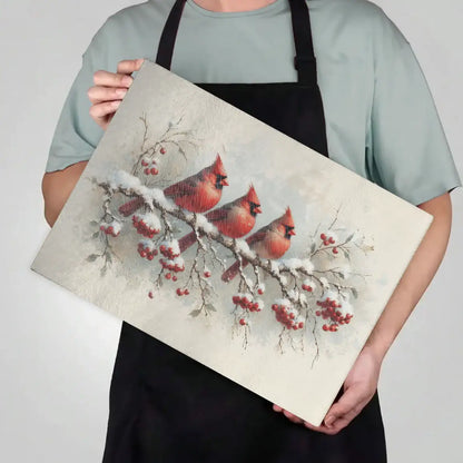 Person holding a decorative mat with cardinals and berries design