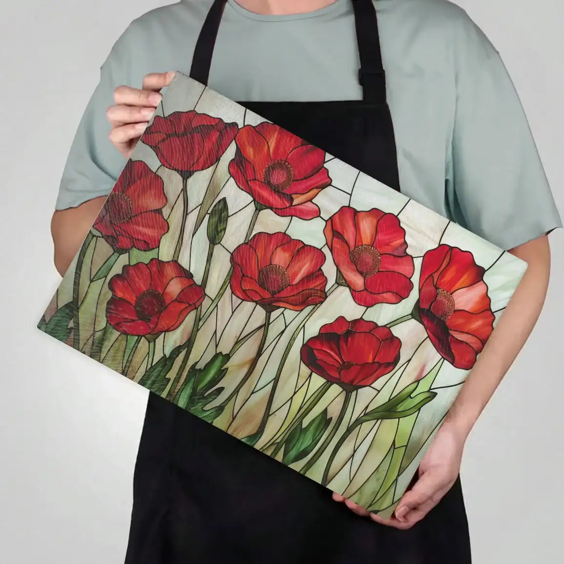 Person holding a tote bag with red floral design