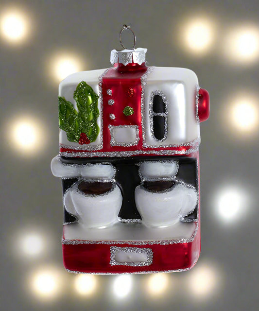 Decorative glass gumball machine ornament with red and white colors on a blurred light background