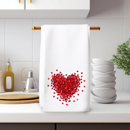 White towel with red heart design hanging on a kitchen rack