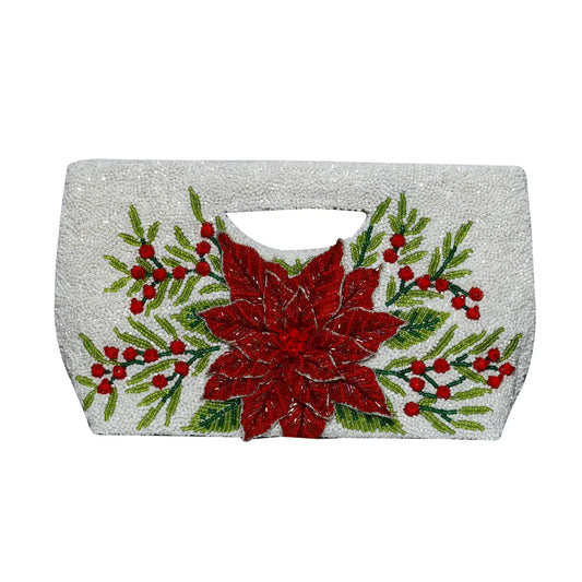 A white textured clutch bag featuring a large red poinsettia and green holly leaf and berry embroidery on the front, with a cutout handle at the top. NY Gift Boutique
