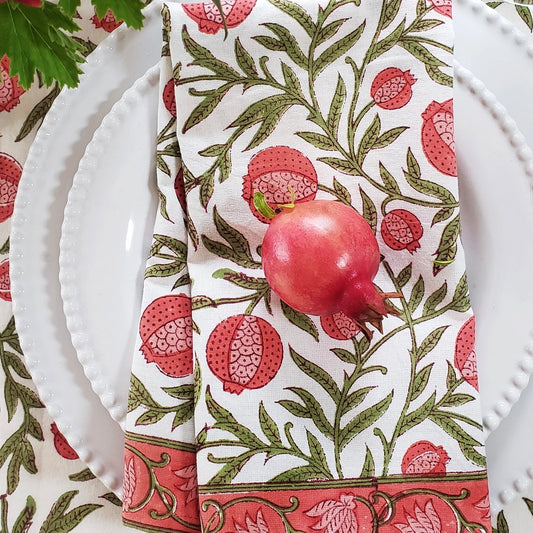 Napkin with pomegranate design on a white plate