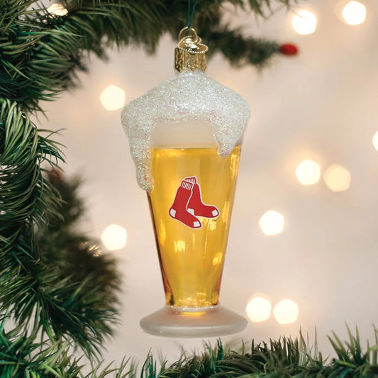 Christmas ornament shaped like a beer glass with a red logo, hanging on a tree.