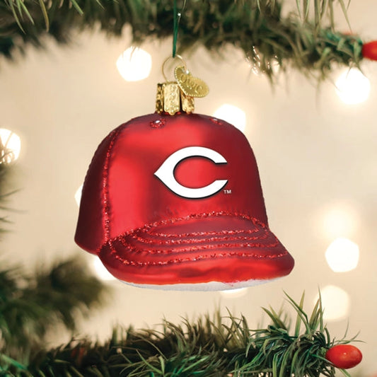 Red glass ornament shaped like a baseball cap with a white 'C' logo on a Christmas tree.