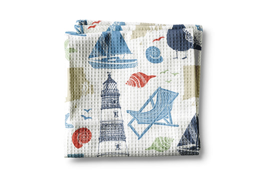 Waffle-textured towel with beach-themed design on a white background
