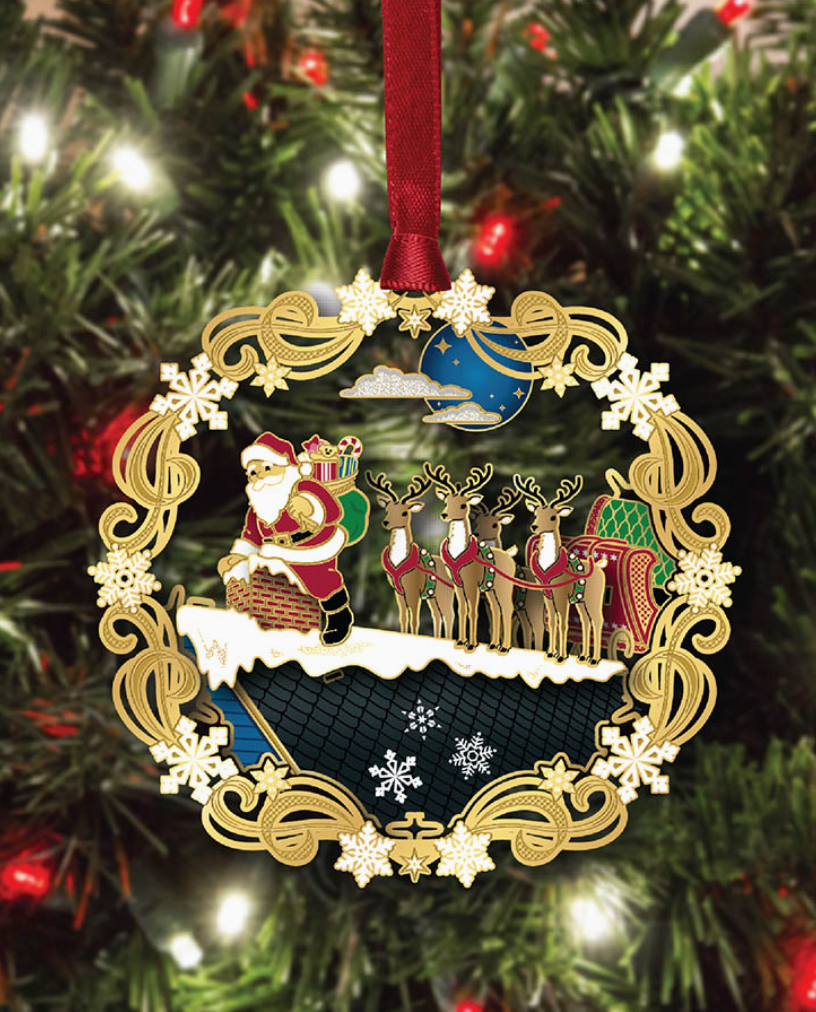 Decorative Christmas ornament with Santa Claus and reindeer on a tree.