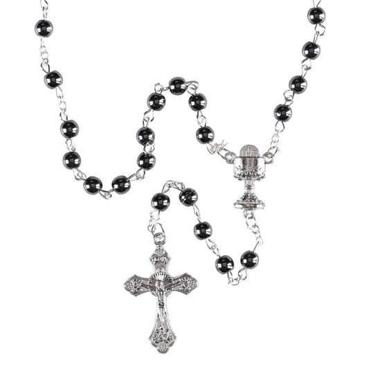 Black rosary with silver crucifixes on a white background