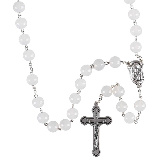 Rosary with white beads and silver cross on a white background