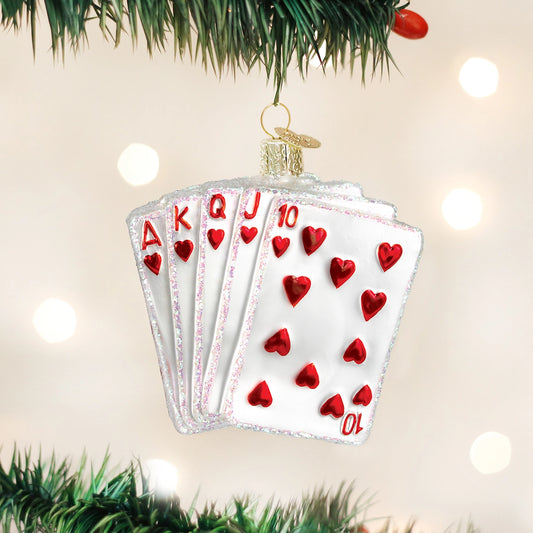 Glass ornament shaped like a fan of playing cards with red hearts on a Christmas tree.