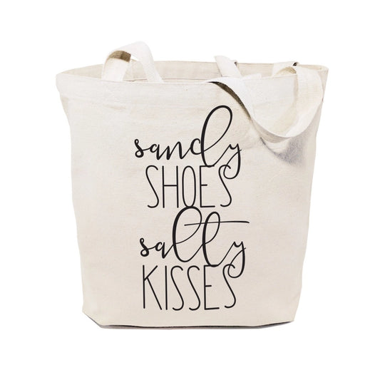 Beige tote bag with 'sandy shoes salty kisses' text on a white background