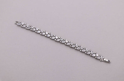 Silver bracelet with clear stones on a gray background