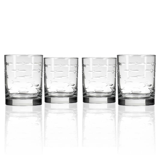 Set of four clear glass tumblers with decorative patterns on a white background