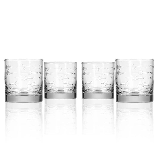 Four clear glass tumblers with silver bases on a white background