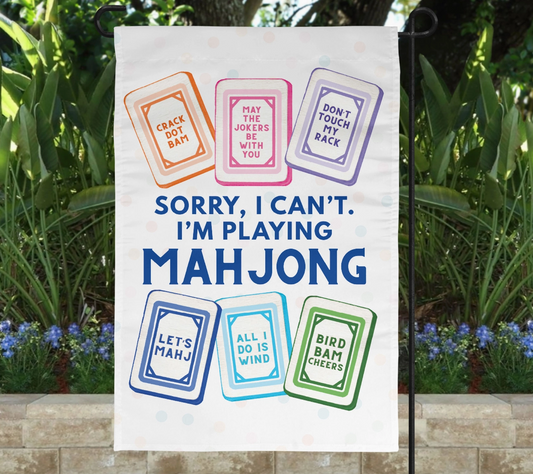 Sorry I Can’t I’m Playing Mahjong 12x18 garden flag displayed outdoors with colorful Mahjong tiles and funny game sayings.