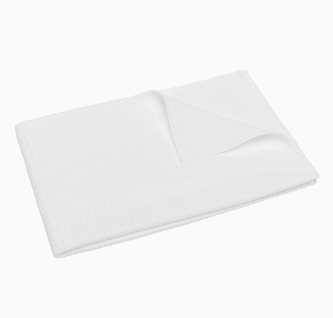 White waffle weave kitchen towel showing absorbent textured fabric