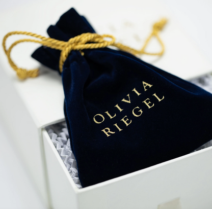 Olivia Riegel navy velvet jewelry storage pouch with gold logo