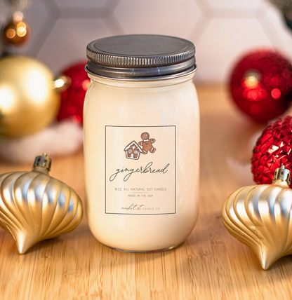 Market Street Candle Co. Gingerbread 16 oz soy candle surrounded by red and gold Christmas ornaments.