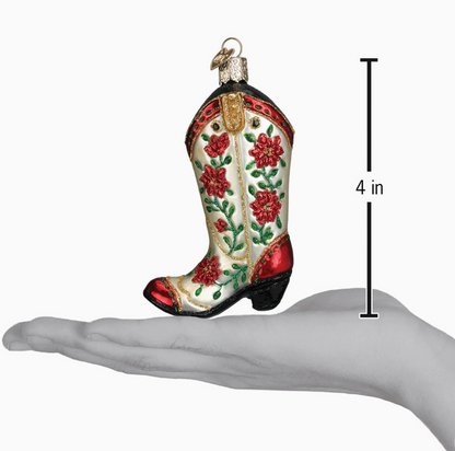 Four-inch cowgirl boot glass Christmas ornament with red floral and green vine details shown for size reference