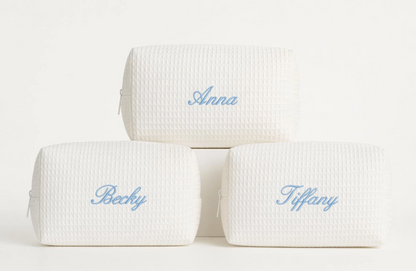 Cream waffle makeup bags personalized with names in light blue script embroidery