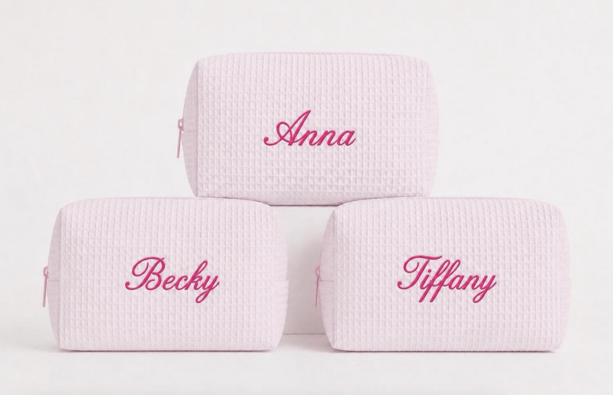 Personalized pink waffle makeup bags with embroidered names in bright pink thread