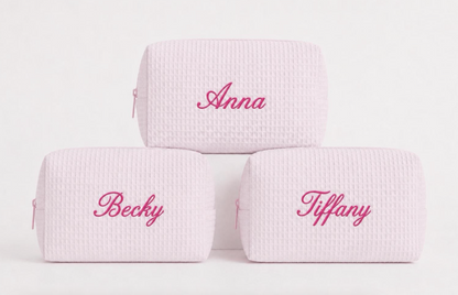 Personalized pink waffle makeup bags with embroidered names in bright pink thread