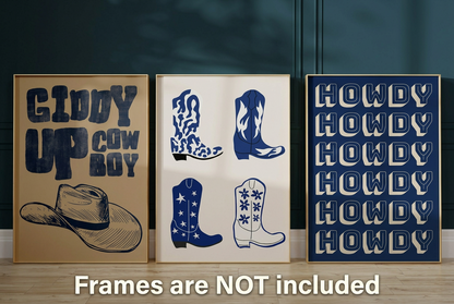 Set of three blue Western cowboy wall art prints with Giddy Up Cowboy lettering, illustrated boots and repeating Howdy typography in wooden frames.