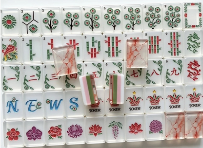 Southern Garden American Mahjong tiles with white botanical faces, pink green striped edges and translucent blush marbled backs
