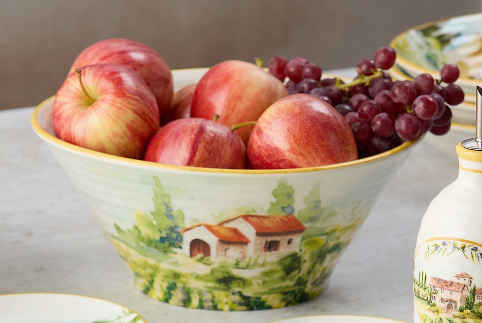 Decorative bowl with apples and grapes on a table