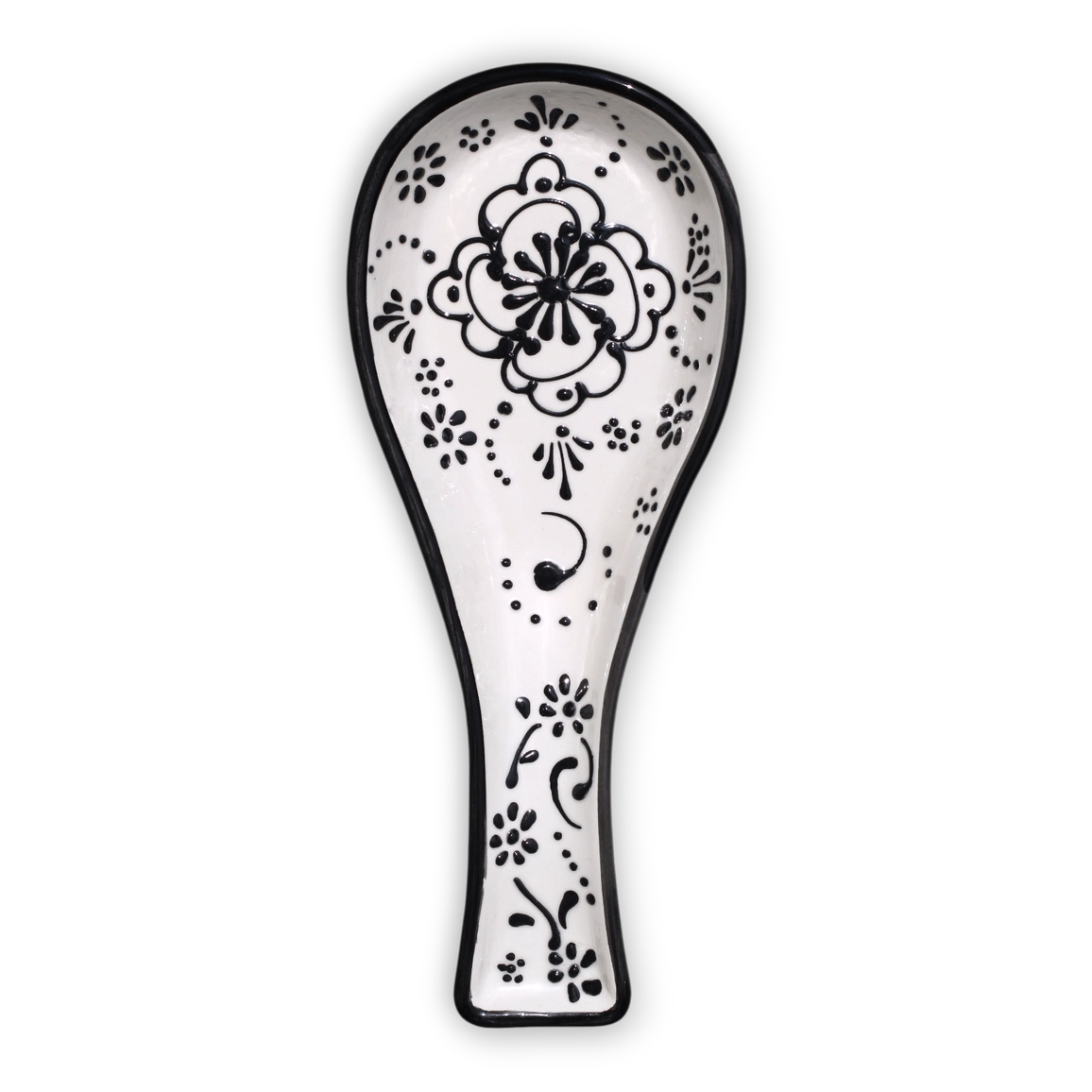 A white ceramic spoon rest with a black hand-painted floral and scroll pattern, shown against a plain white background.
