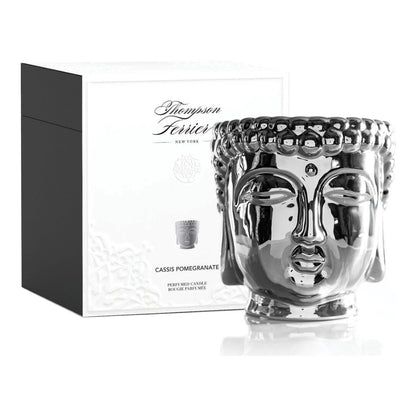 Silver Buddha face candle with packaging on a white background